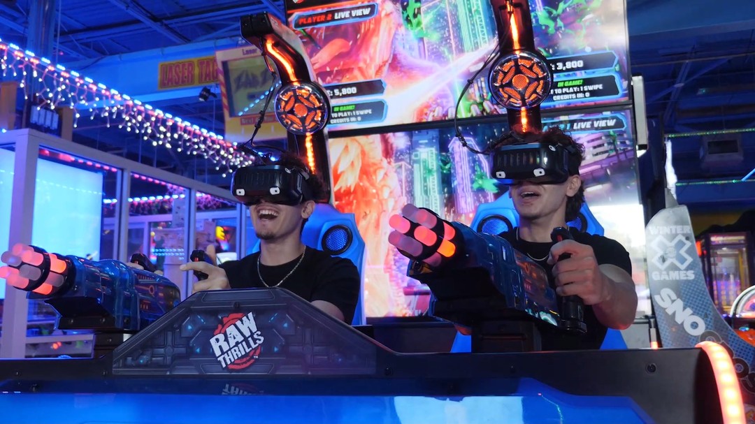 Two men playing VR arcade shooter game