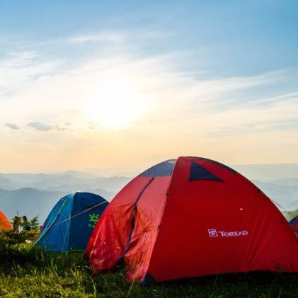 Camping tents on mountain at sunrise